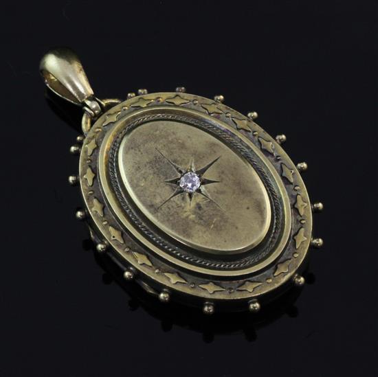 A Victorian 15ct gold and diamond set oval pendant locket, 1.75in excl. bale.